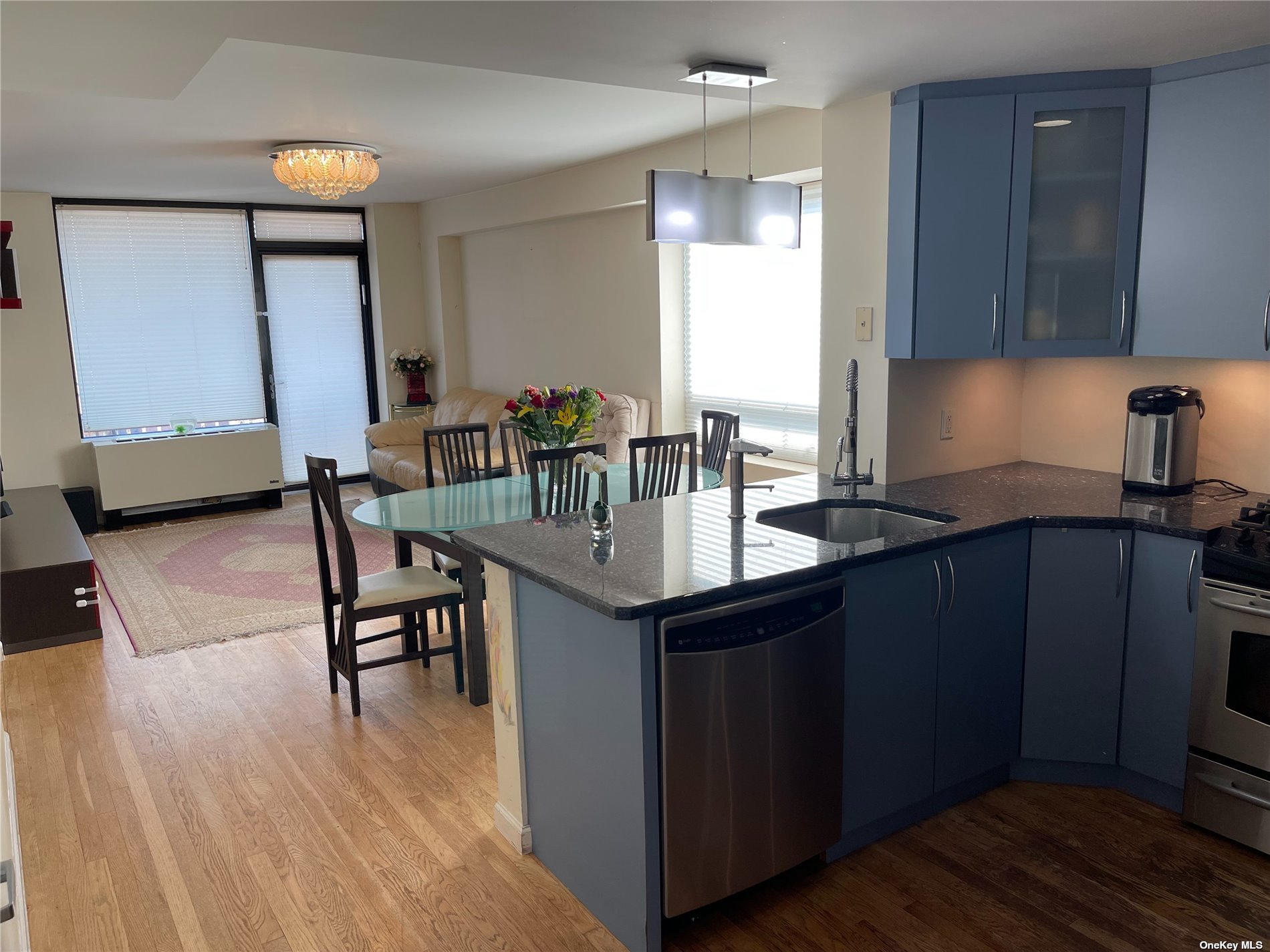 a kitchen with a sink cabinets and wooden floor