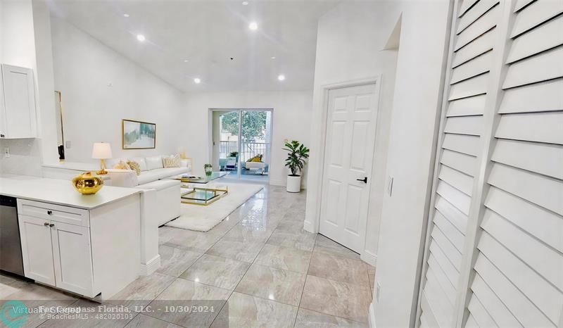 a large white kitchen with a sink