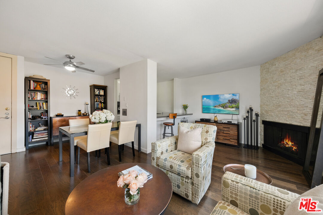 a living room with furniture a fireplace and a table