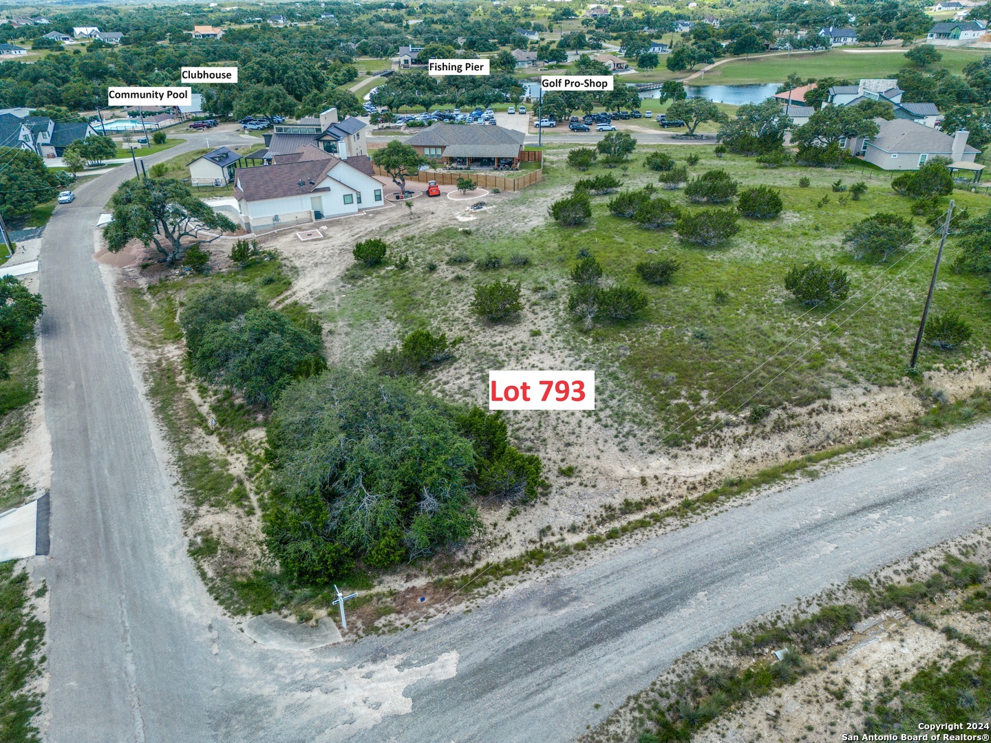 an aerial view of residential house and car parked on street side