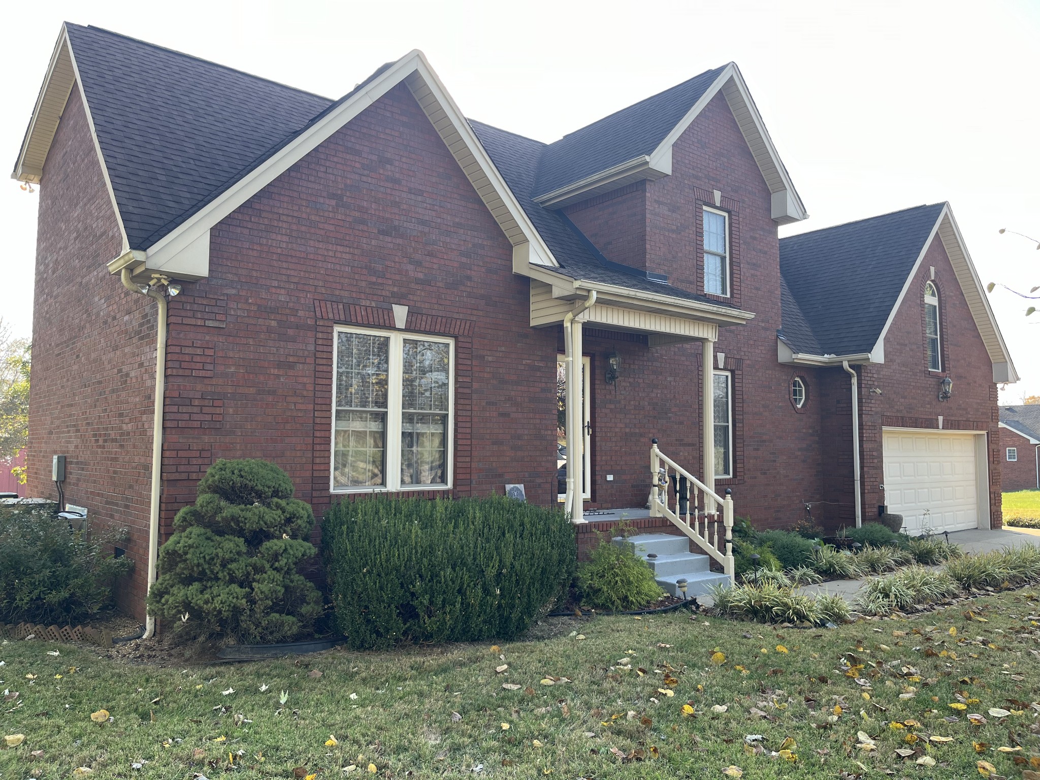 a view of a brick house next to a yard