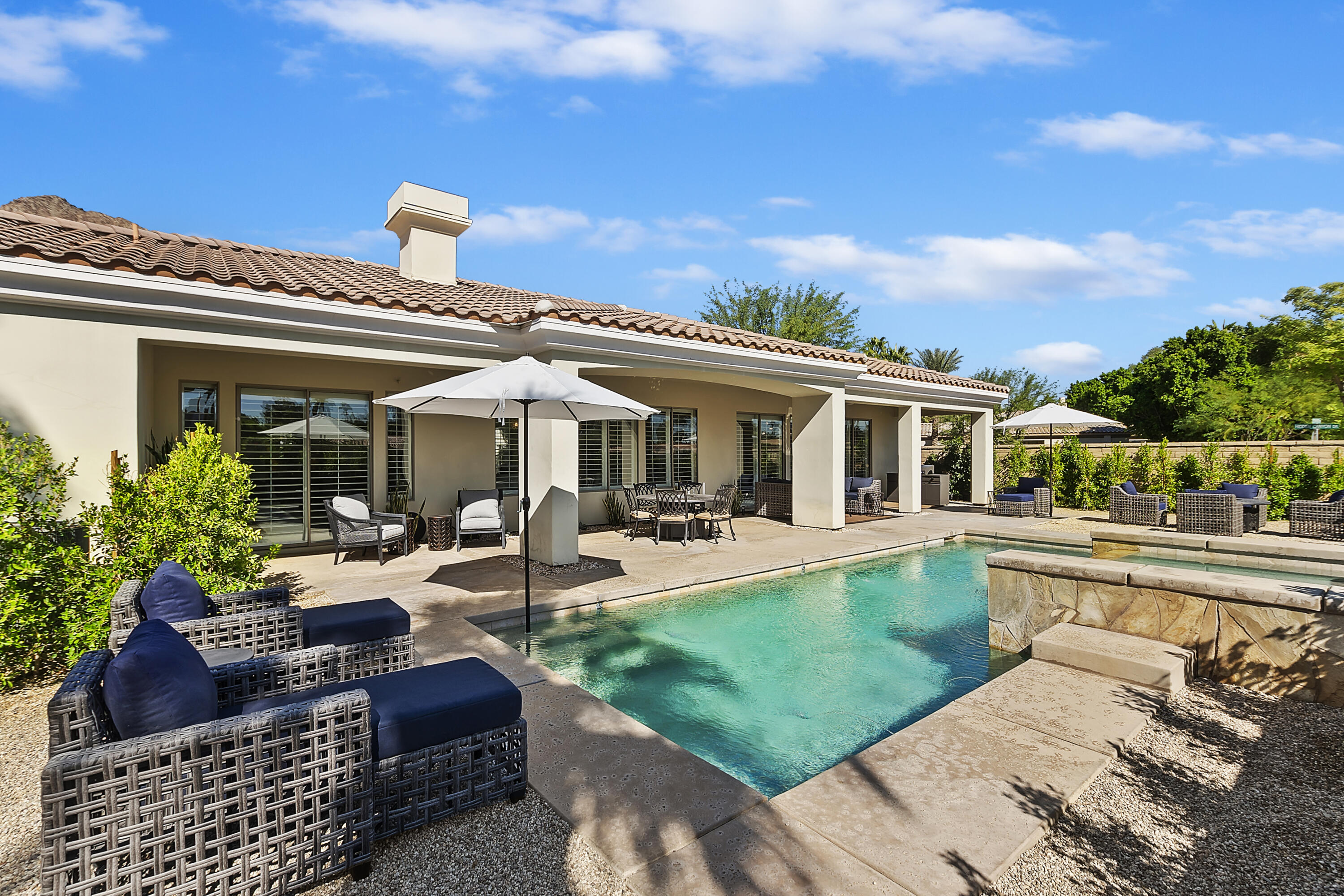 a view of a house with swimming pool and furniture