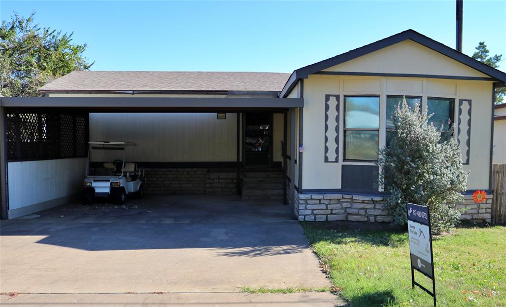 a view of front door and small yard