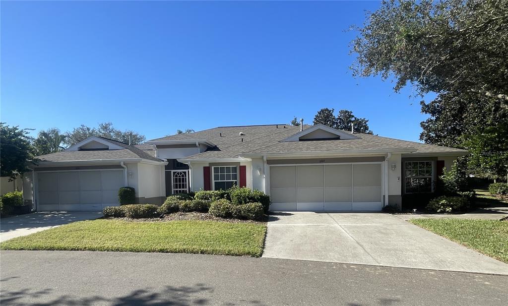 a front view of a house with a yard and a garage