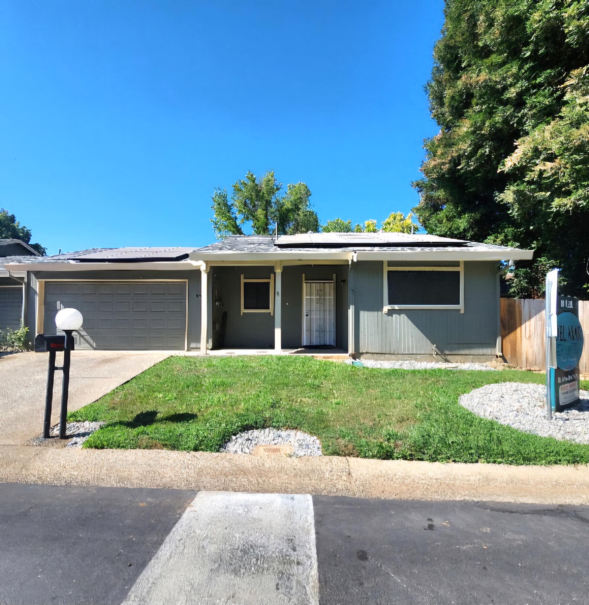 a front view of a house with a yard and a garage