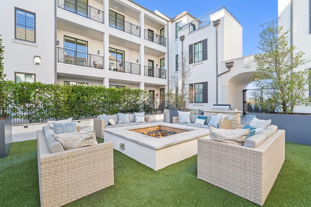 a view of a building and couches in the back yard