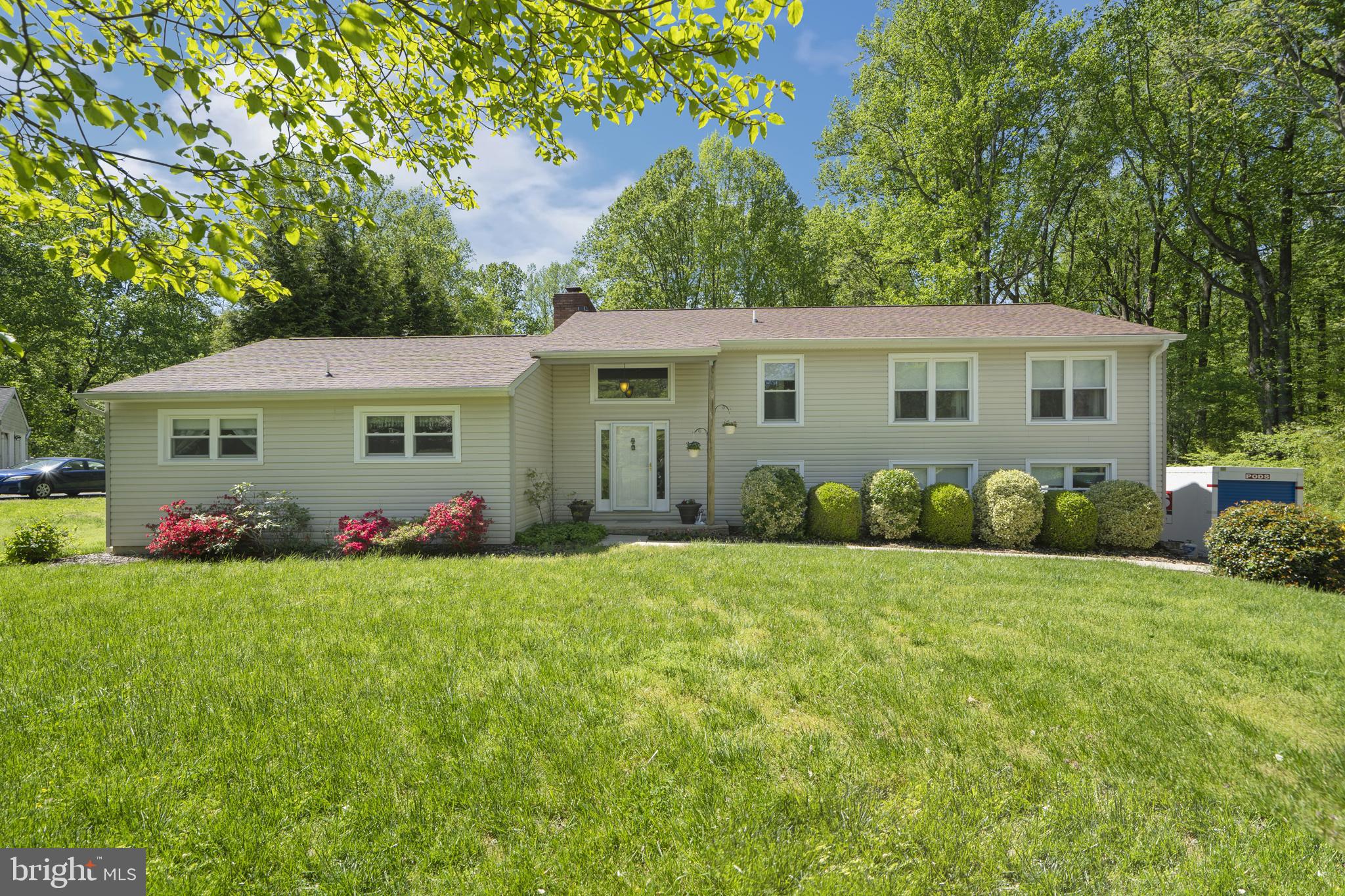 a view of a house with a big yard and potted plants