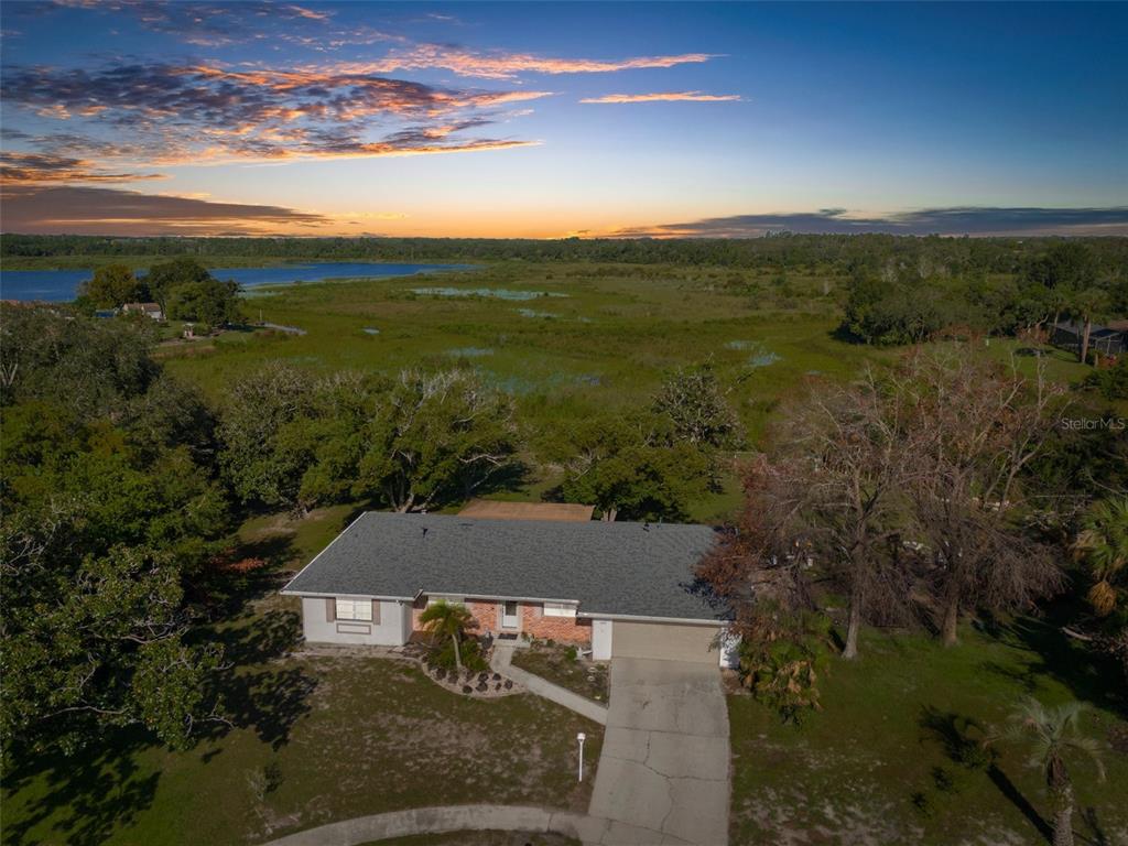 an aerial view of a house with a yard