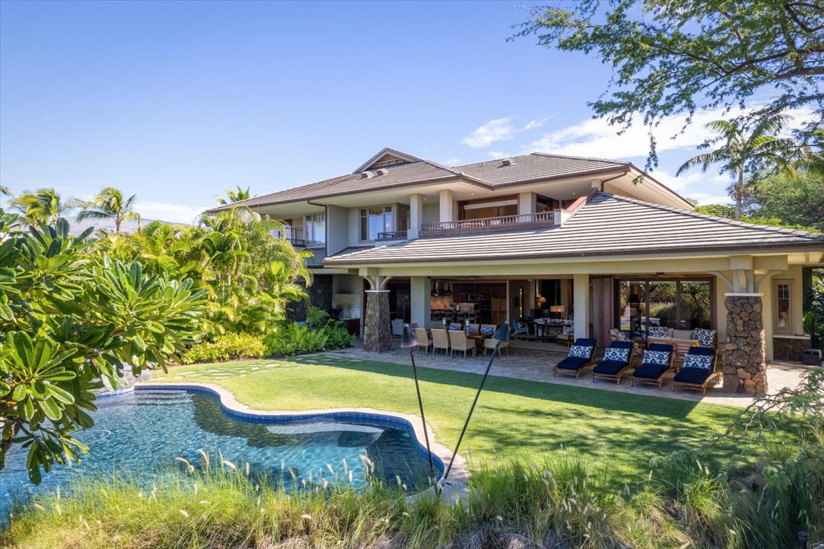 a view of a house with swimming pool and sitting area