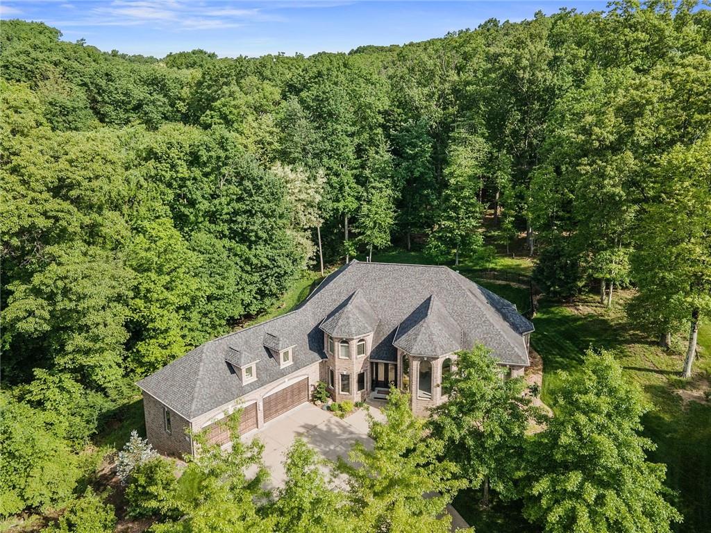 an aerial view of a house with yard and outdoor seating