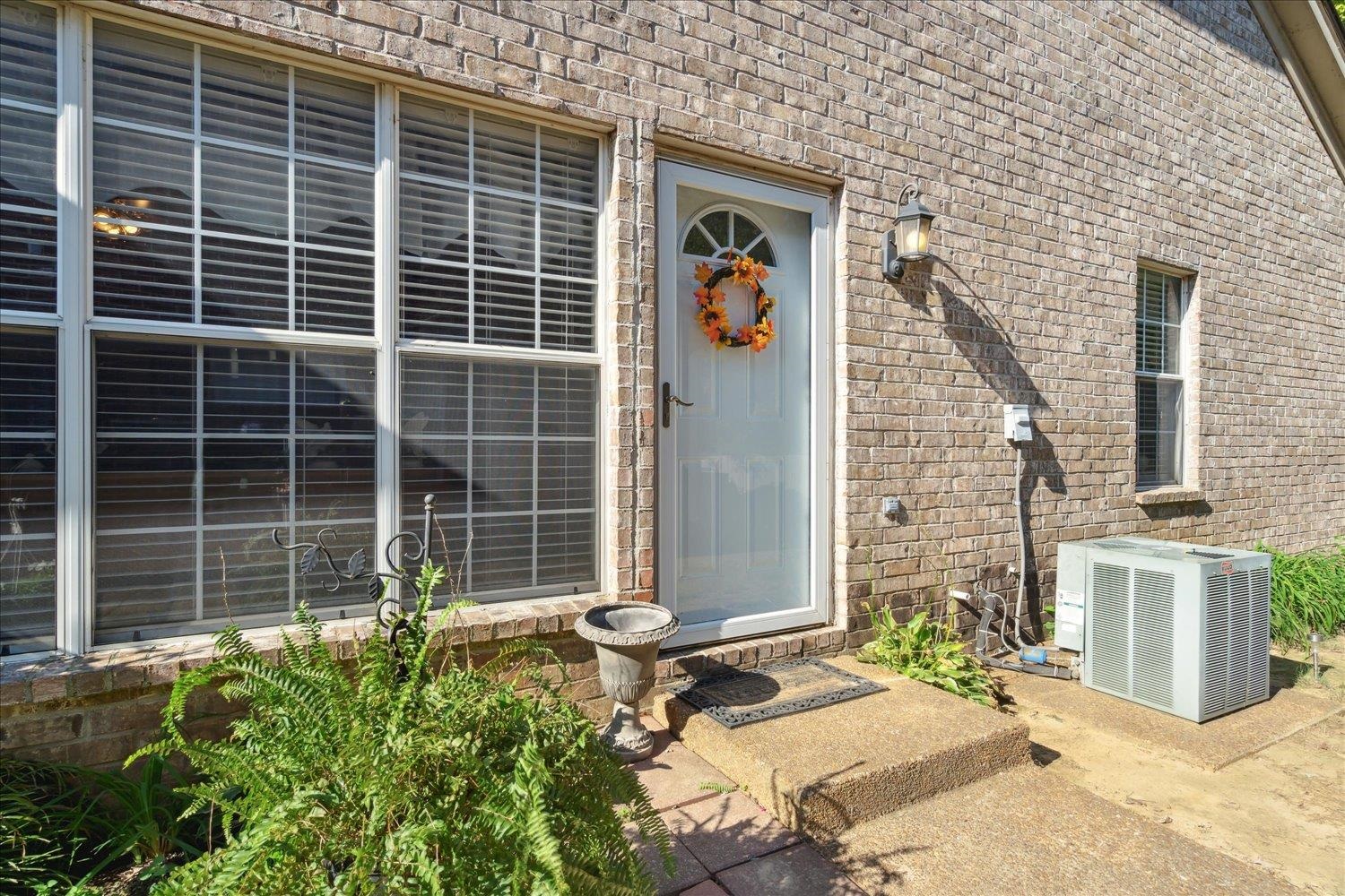 a front view of a house with a potted plant