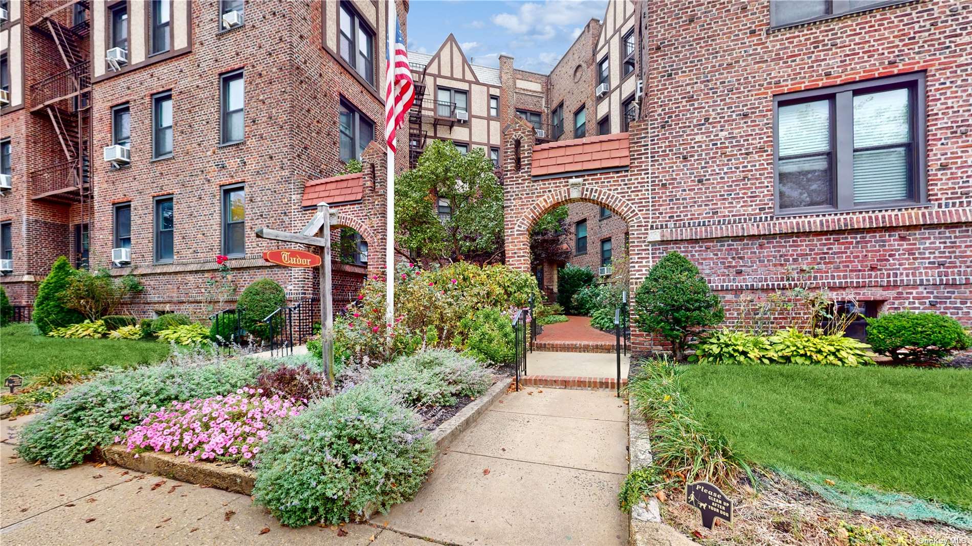 a front view of a multi story residential apartment building with yard