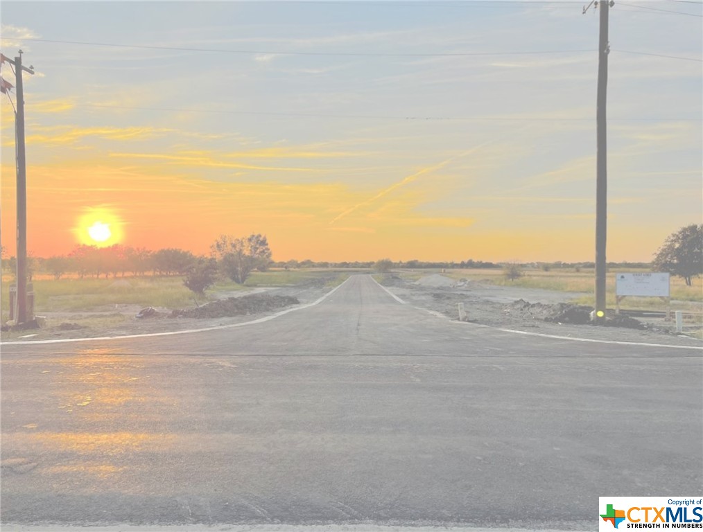 a view of a road with an ocean view