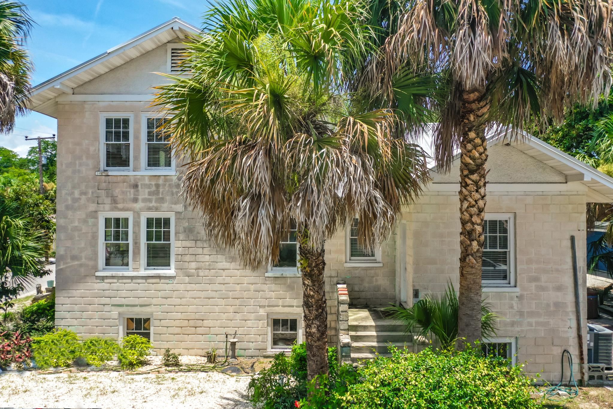 a view of a house with a tree in front