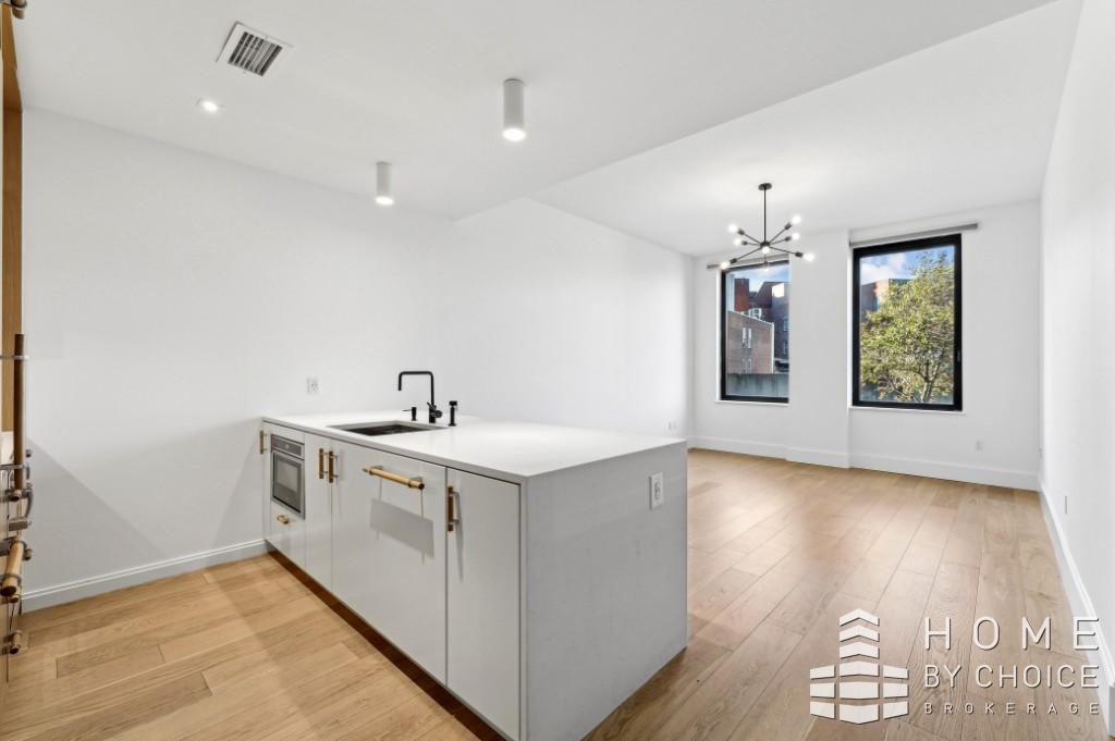 a view of a kitchen sink and chandelier