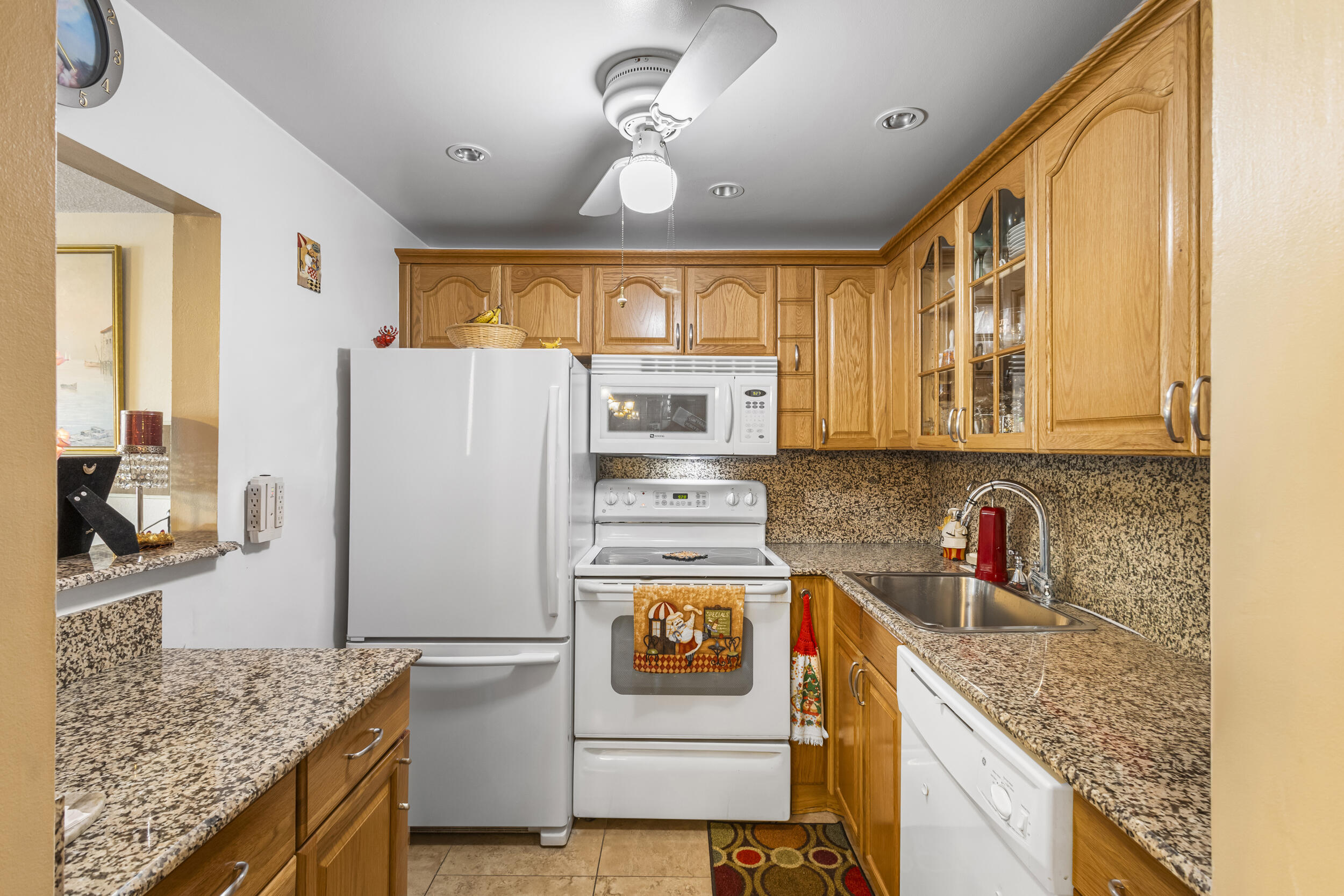 a kitchen with stainless steel appliances granite countertop a refrigerator a stove and a sink with cabinets