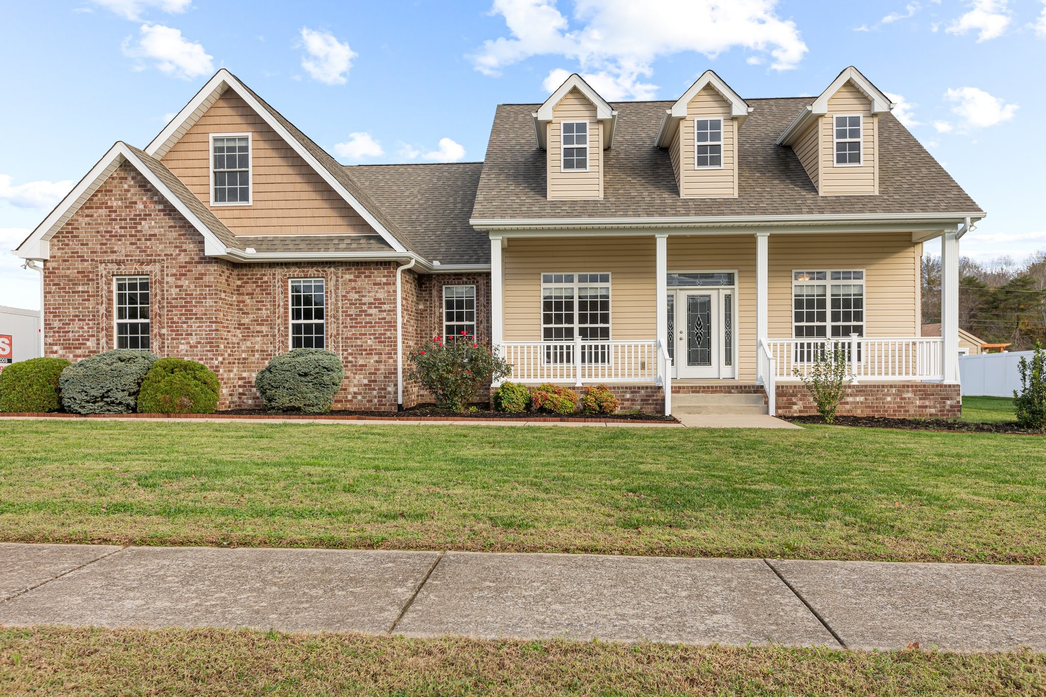 a front view of a house with a garden