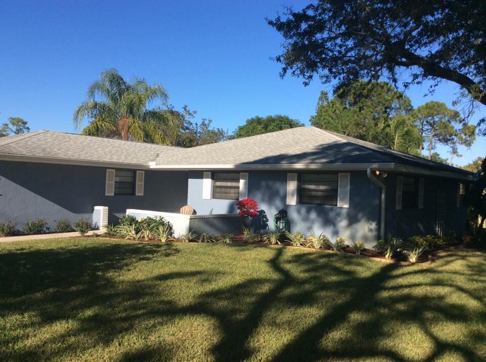 a view of a house with yard and sitting area