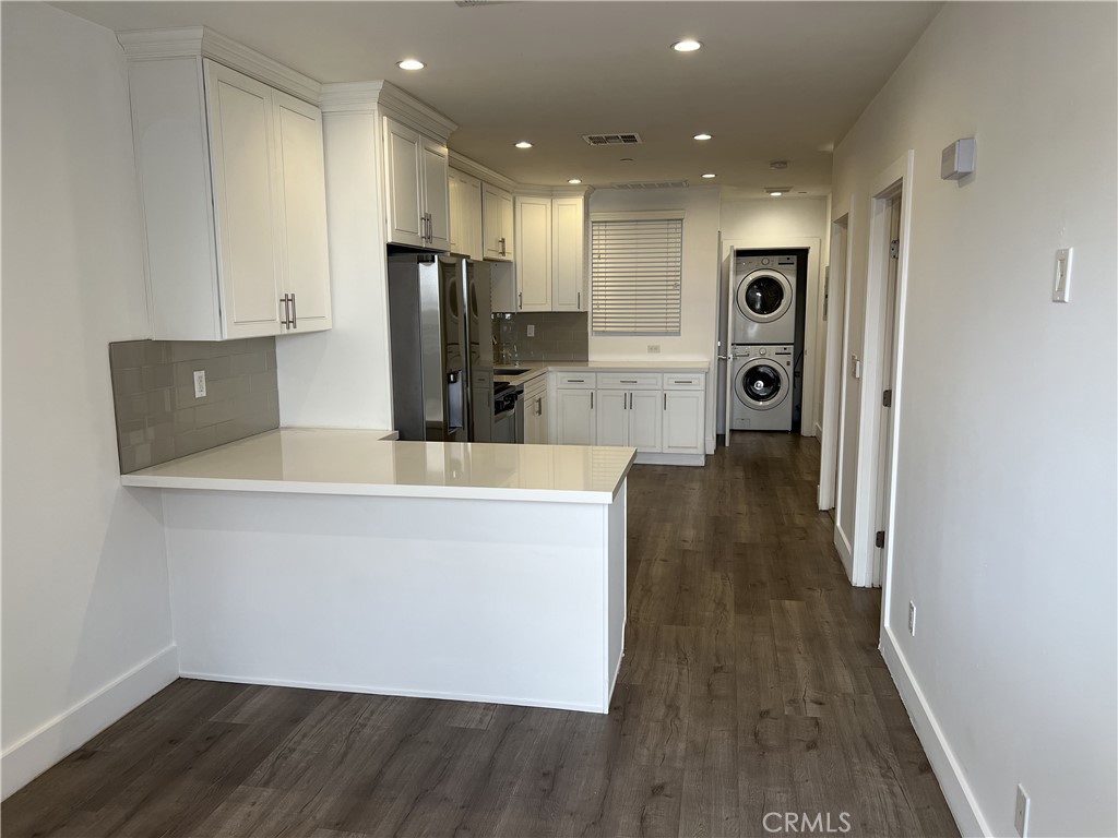 a view of a kitchen with wooden floor