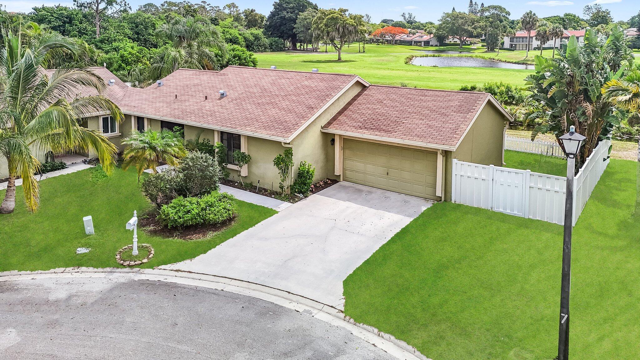 a aerial view of a house with garden space and a patio