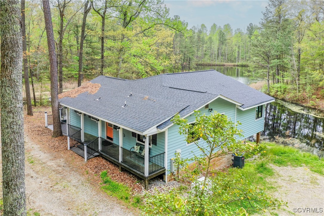 an aerial view of a house with yard and green space