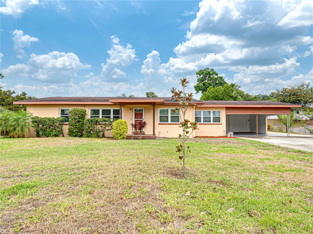 a front view of house with yard and green space