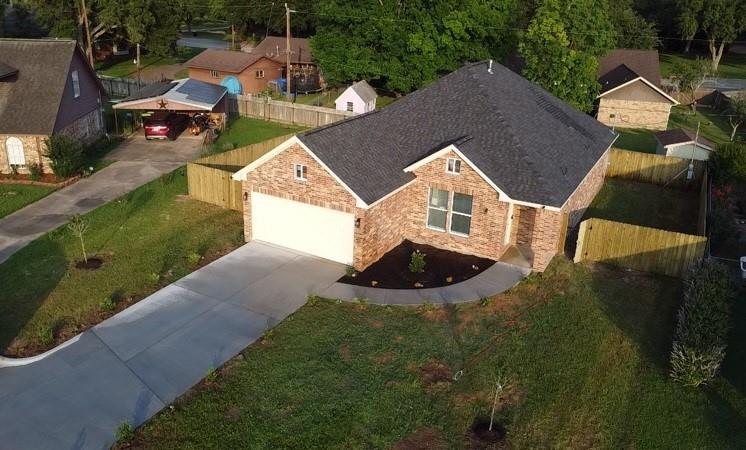 an aerial view of a house with backyard