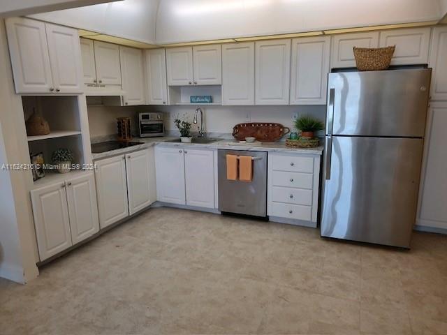 a kitchen with white cabinets and white appliances