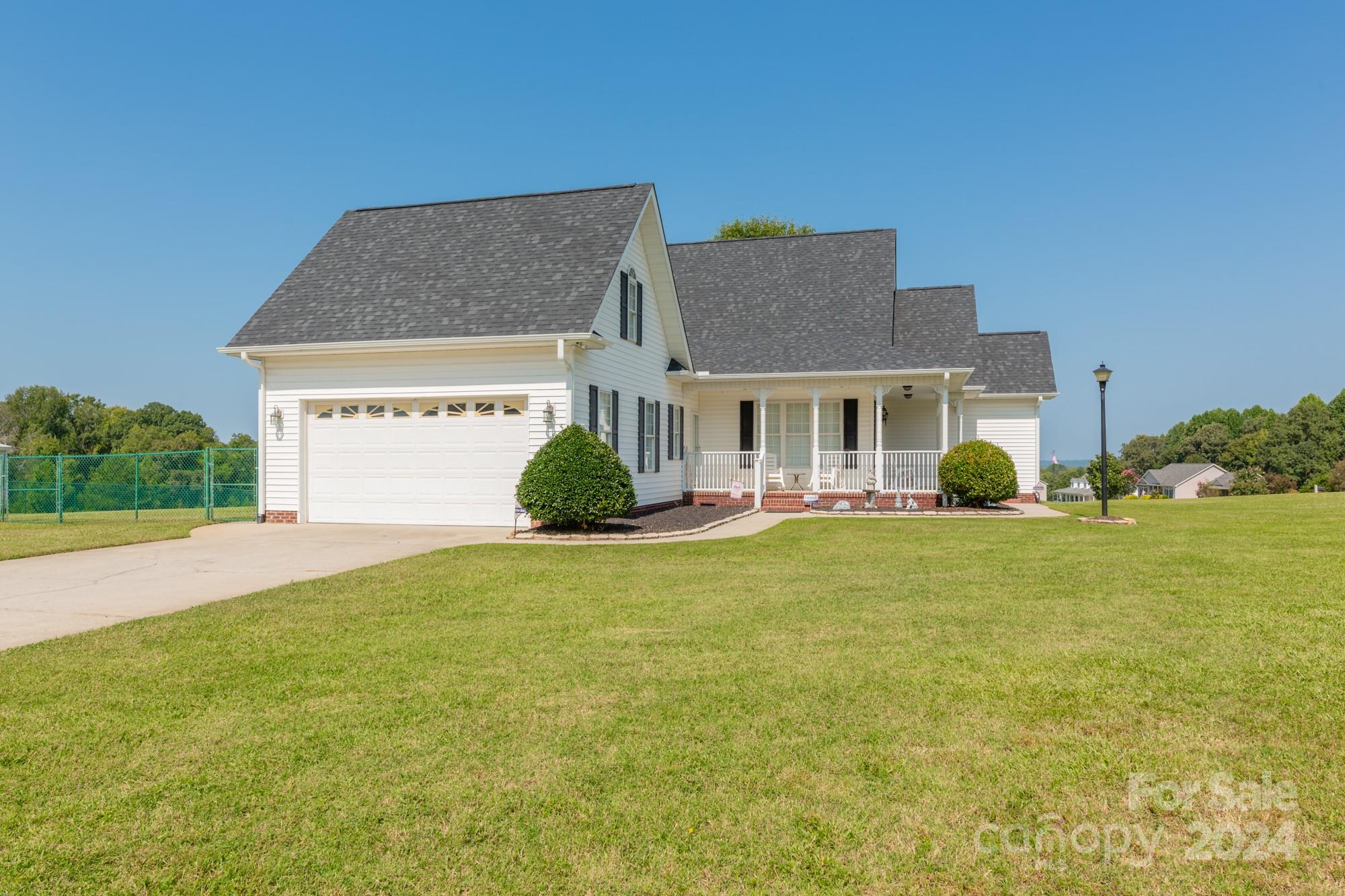 a view of a house with a backyard