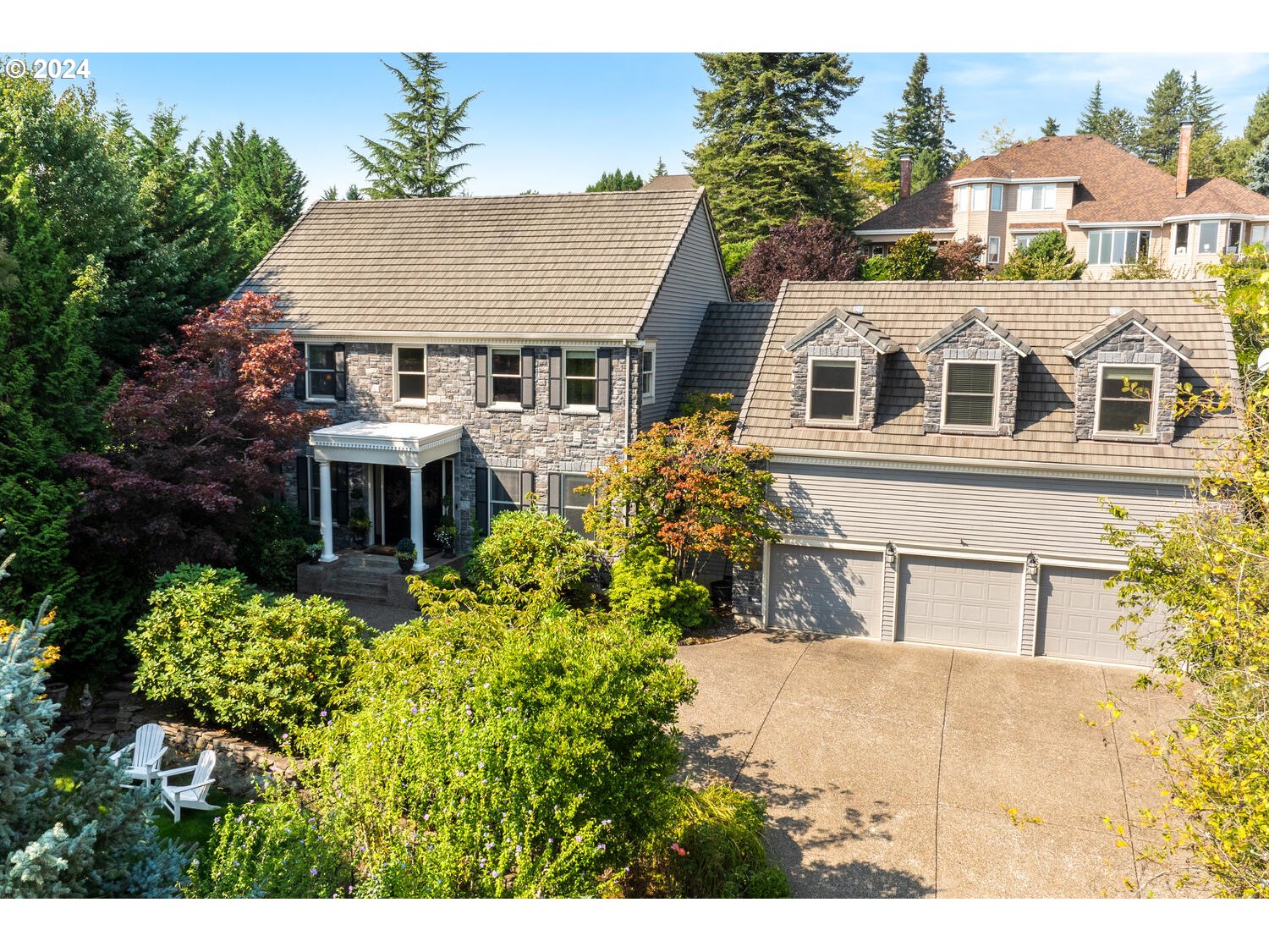 a aerial view of a house with a yard and potted plants