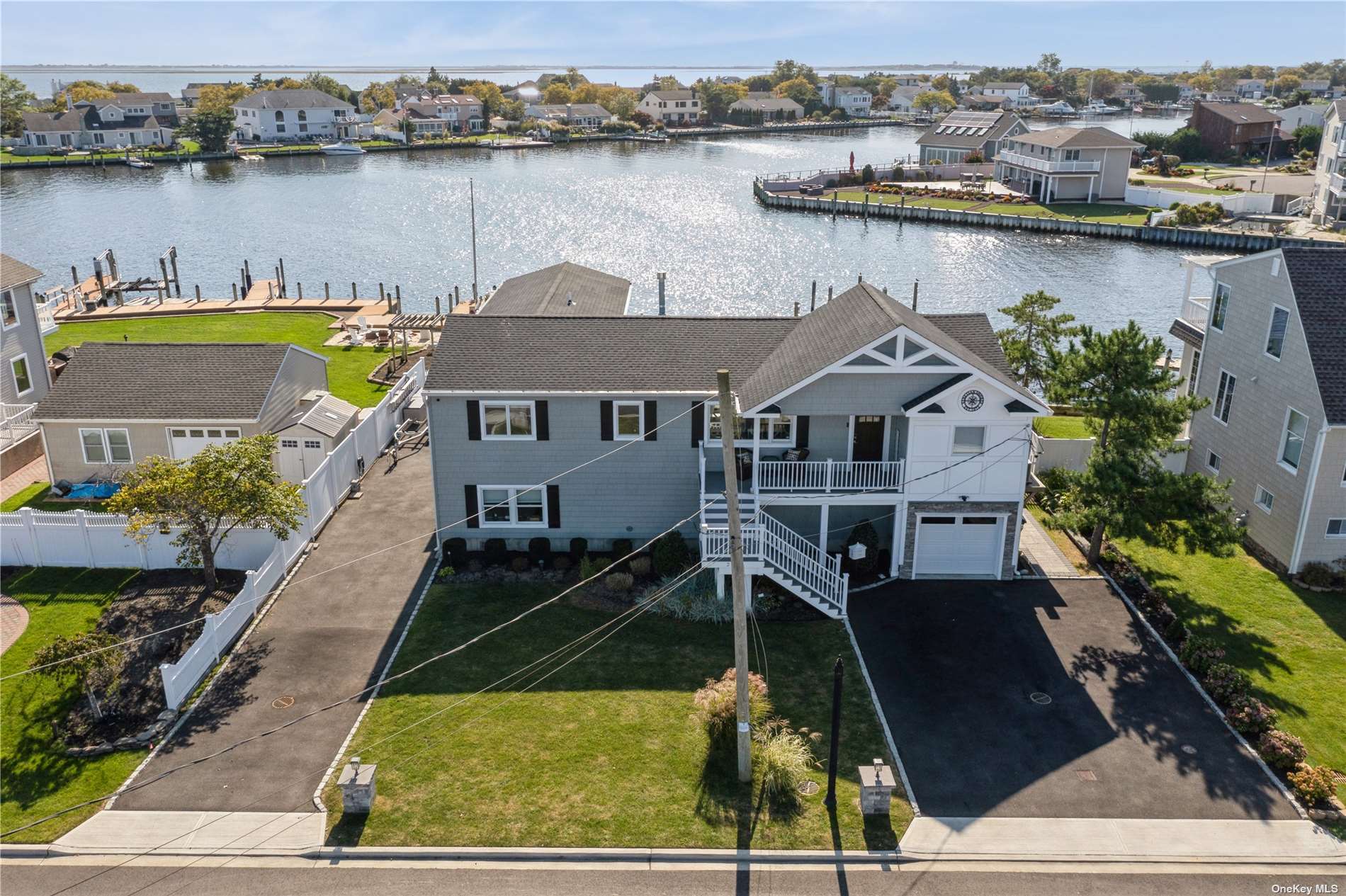 an aerial view of a house with outdoor space and lake view