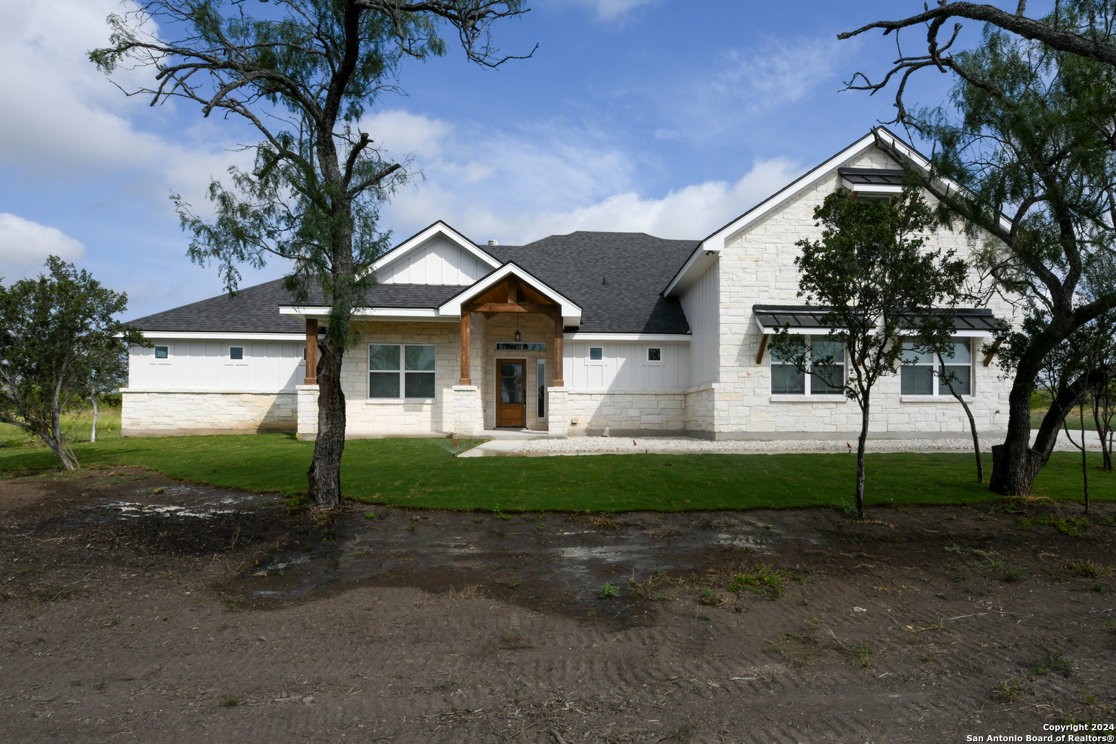 a front view of a house with garden