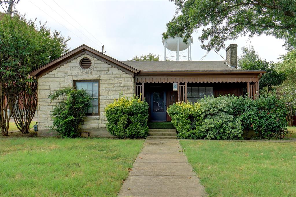 a front view of house with a garden