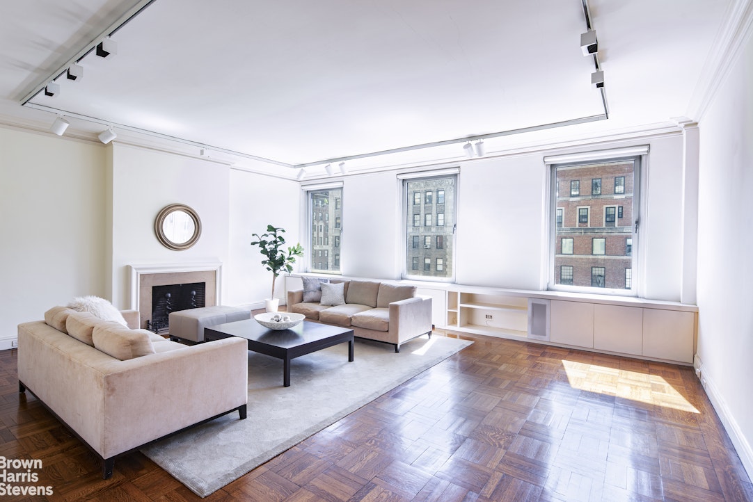 a living room with furniture fireplace and window