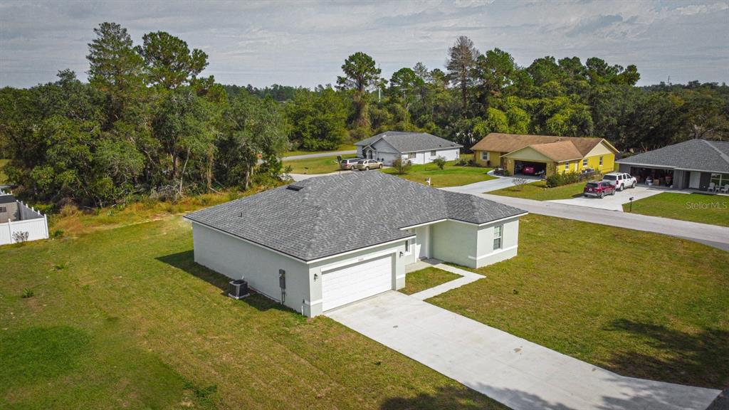 a aerial view of a house with swimming pool garden and patio