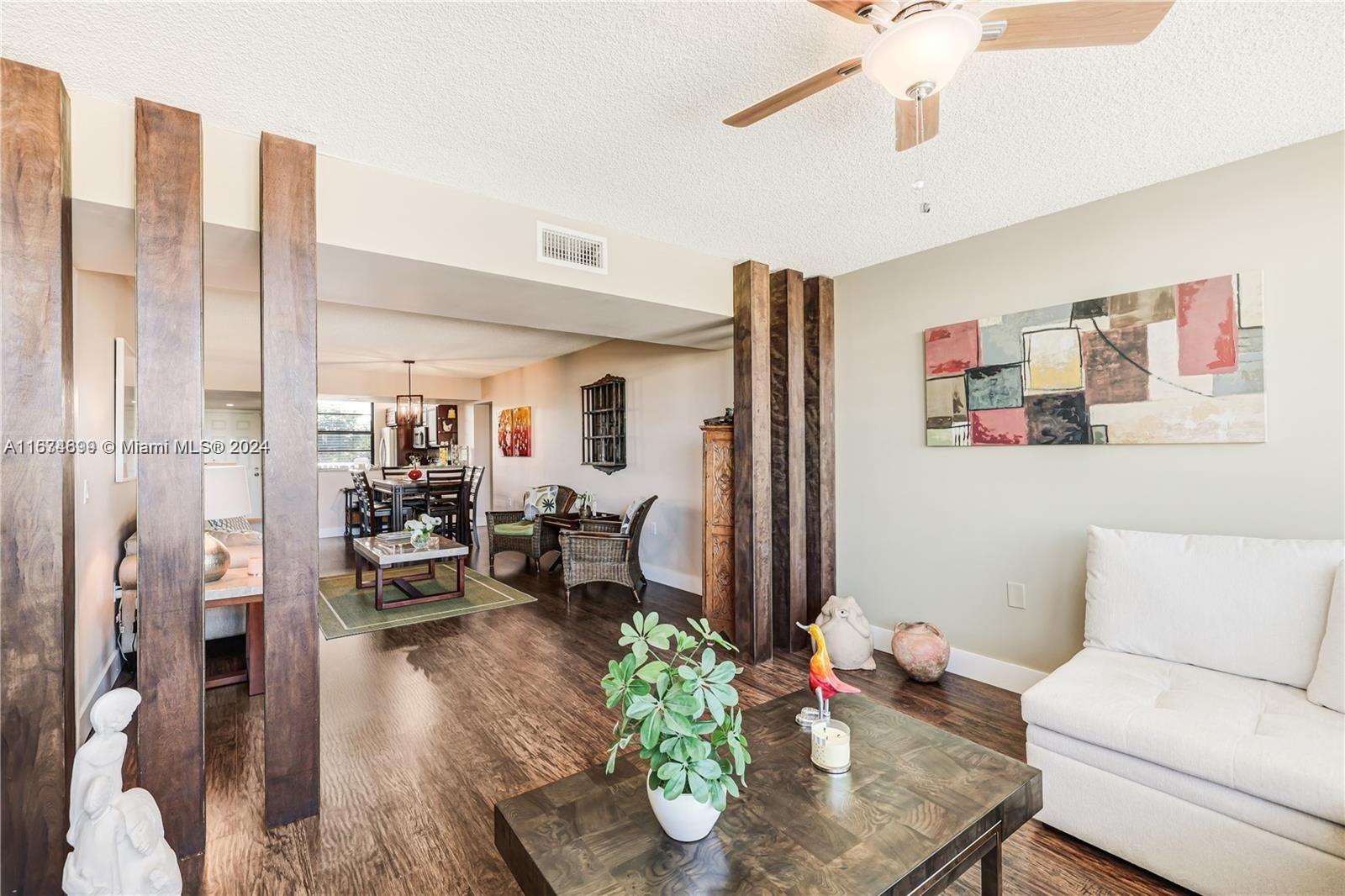 a living room with furniture dining table and a chandelier