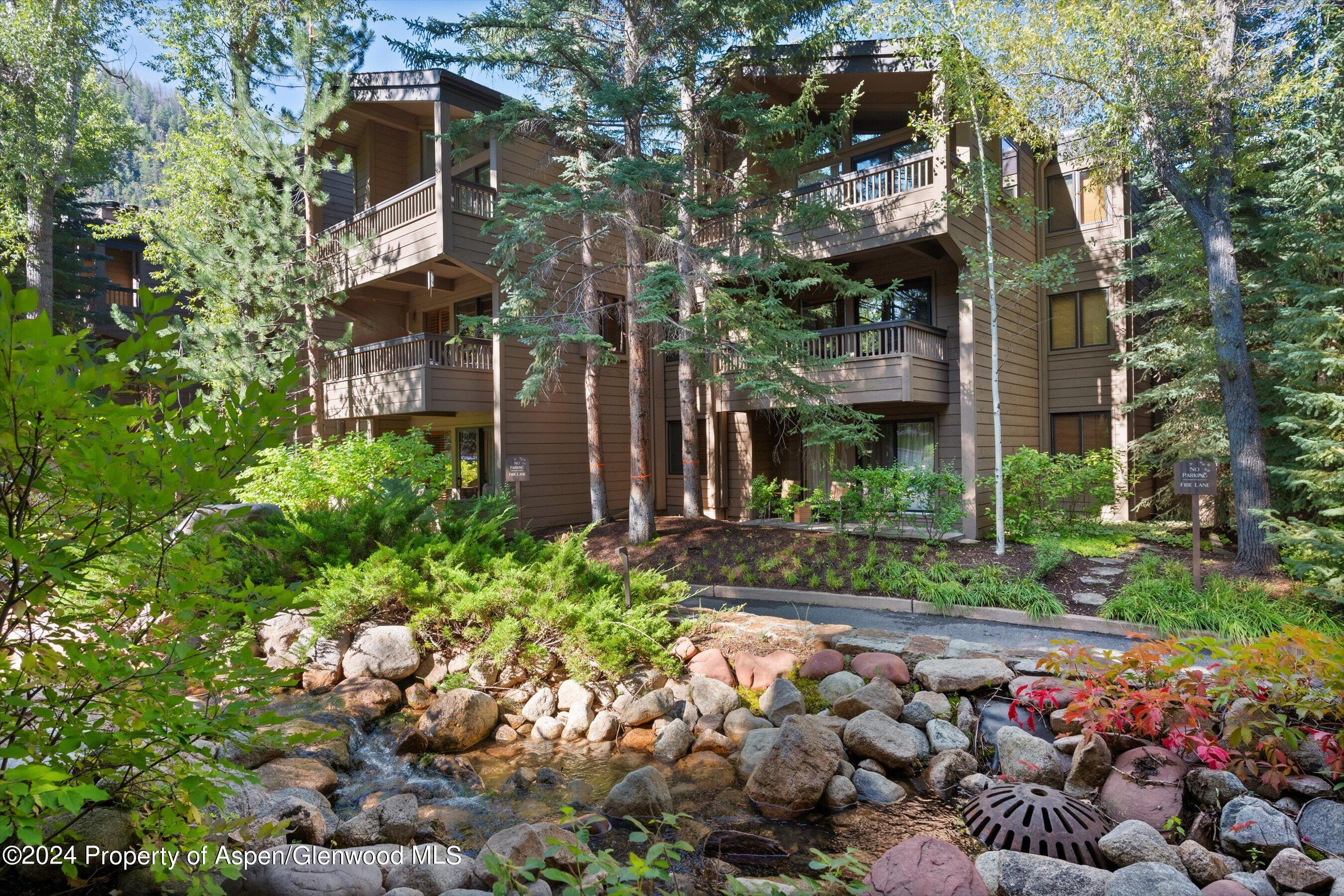 a view of a house with a yard and garden