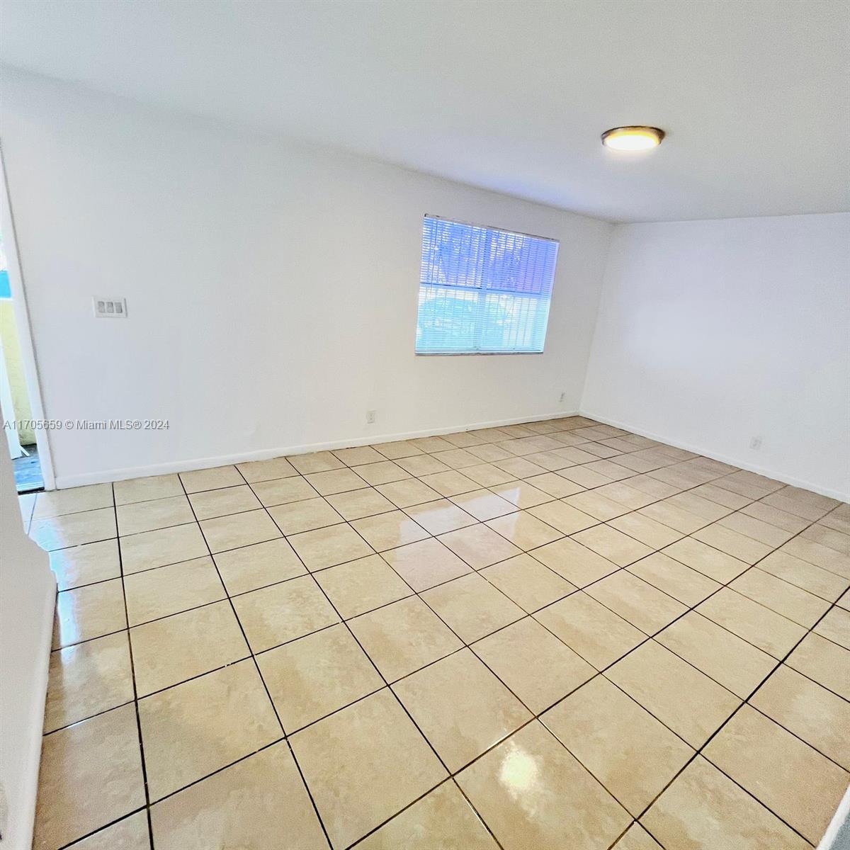 a view of an empty room and entryway