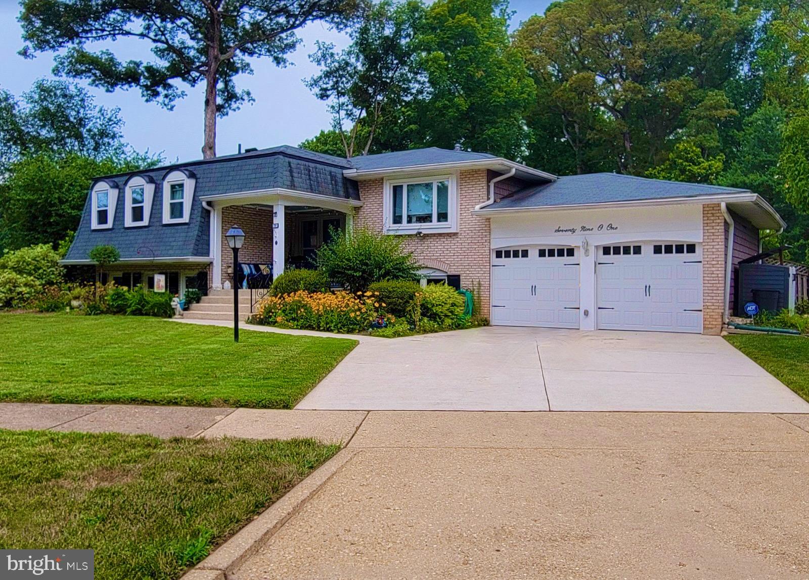 a view of a house with a yard and tree s