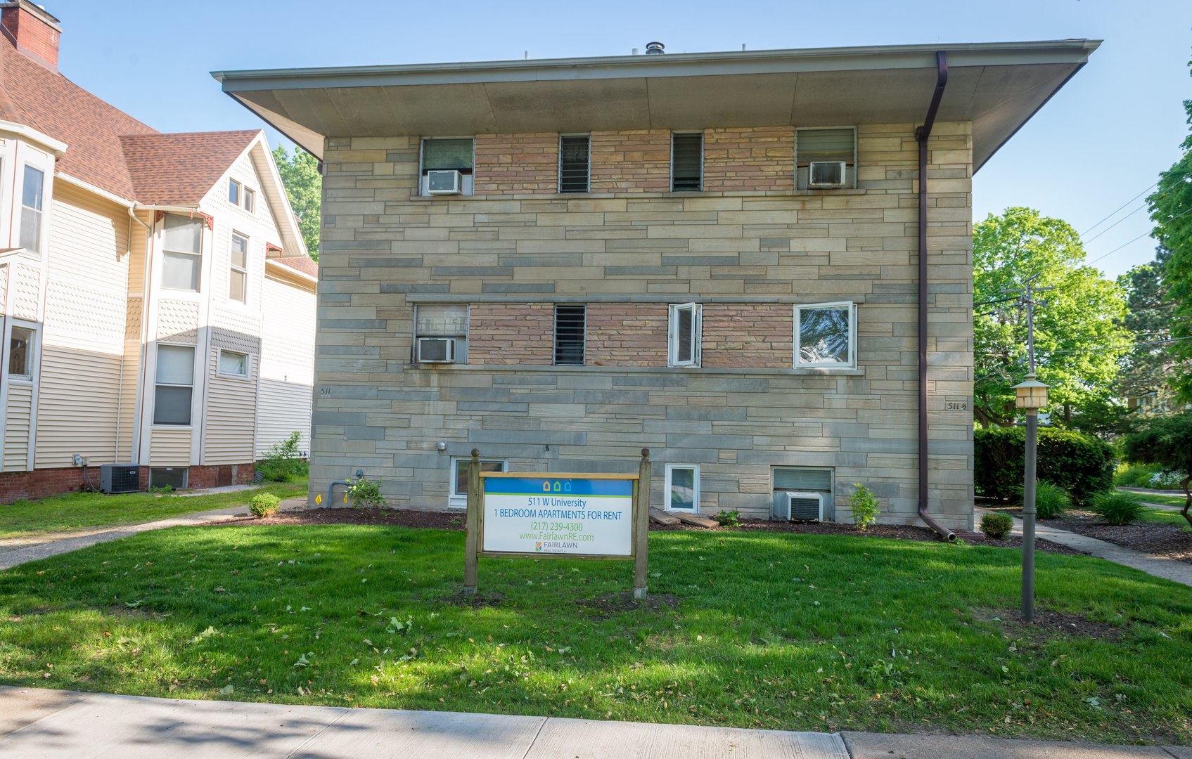 a brick building with a yard