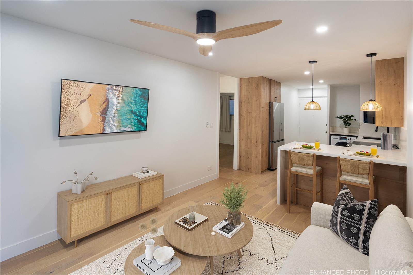 a living room with furniture and kitchen view