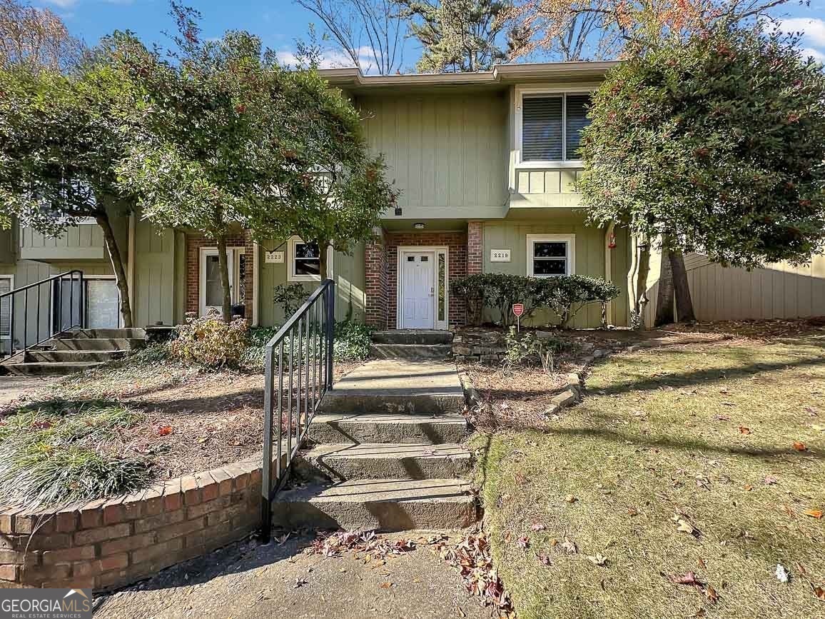 a front view of a house with garden