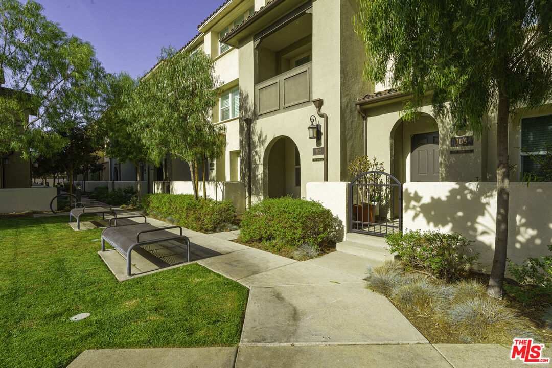 a view of a house with backyard and sitting area