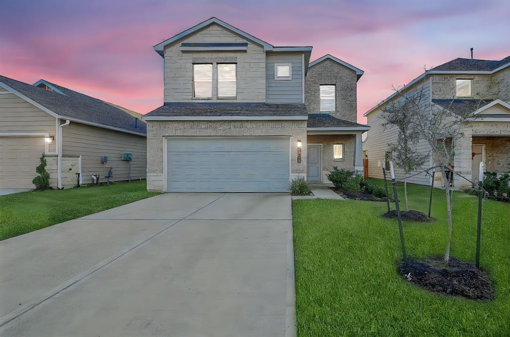 This home says perfection at any time of day! The 2 story brick residence is located at 21507 Cypress Trellis Drive, Cypress, TX, in the Cypress Oaks North community. Shown here is the roomy driveway beneath the dual-vehicle attached garage.