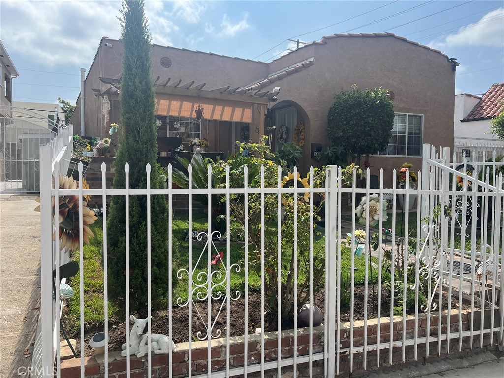 a view of a house with a small yard and plants