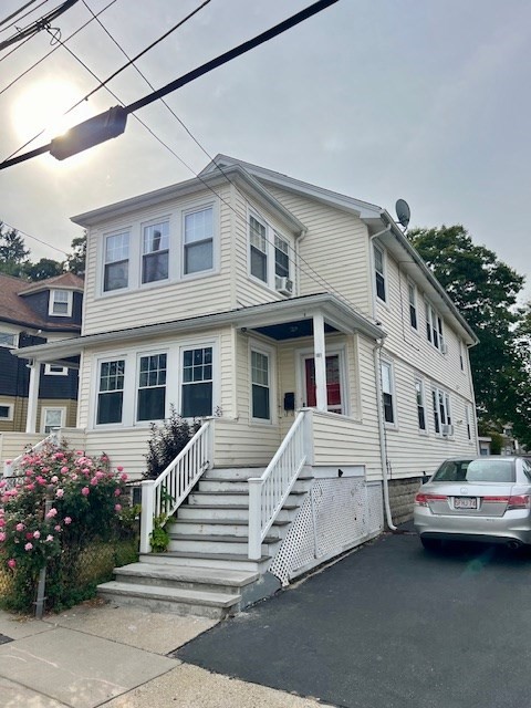 a front view of a house with a garden