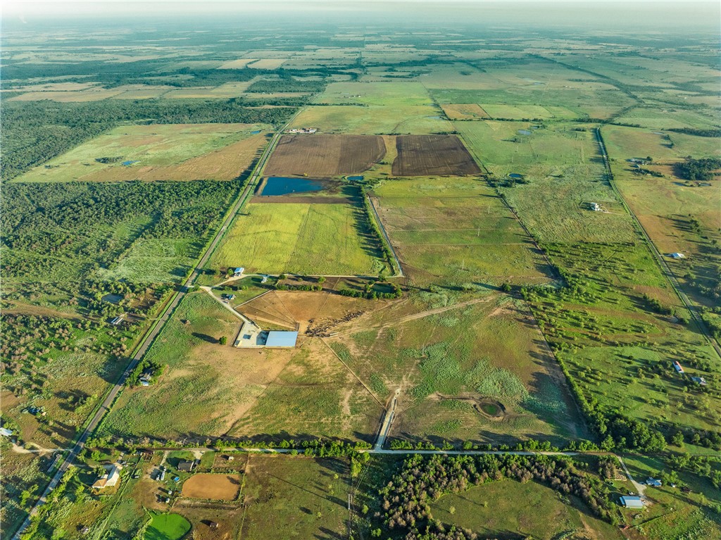 Birds eye view of property featuring a rural view