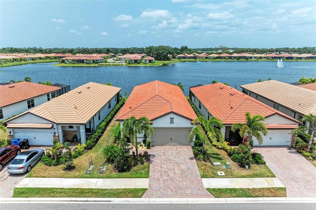 an aerial view of a house with garden space and lake view