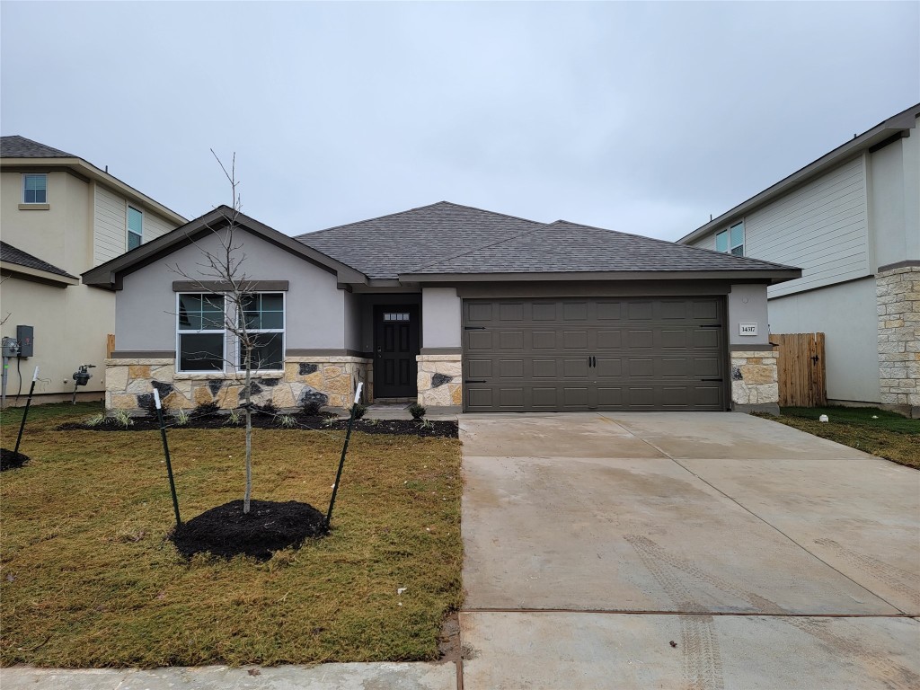 a front view of a house with garden