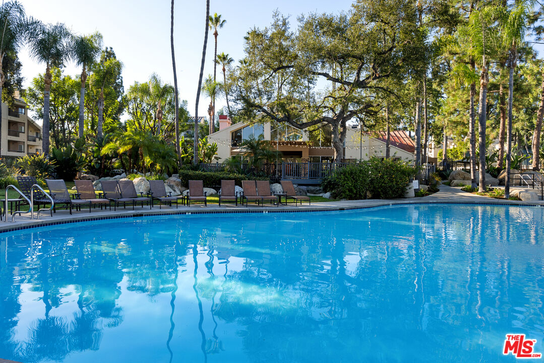 a view of swimming pool with outdoor seating and plants